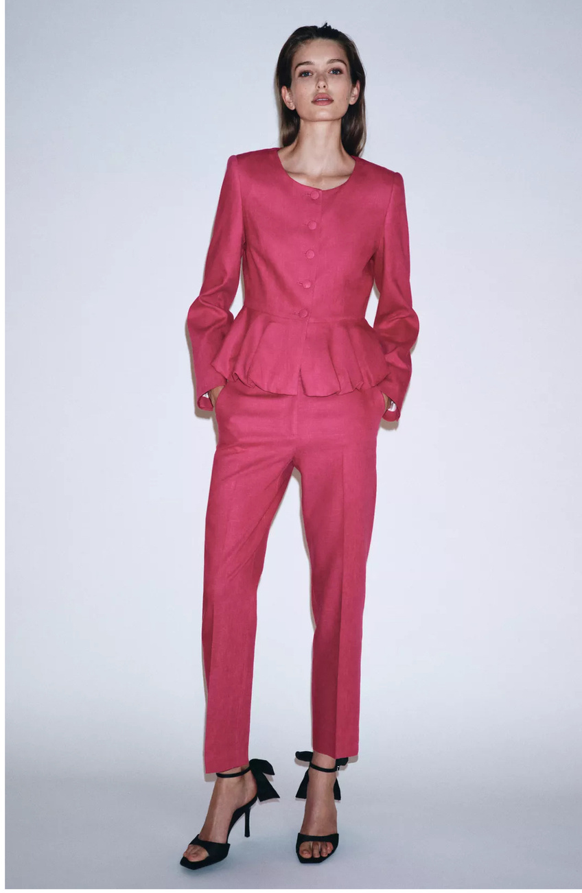 Woman styled in a vivid pink suit
