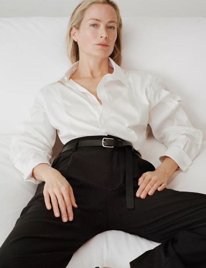 Woman styled in a crisp white shirt and black trousers